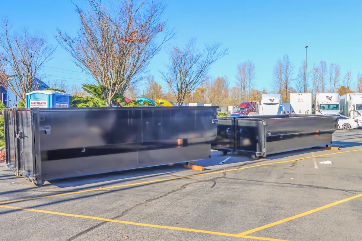 Professional dumpster rental service with roll-off container on residential driveway in Gulf Hills